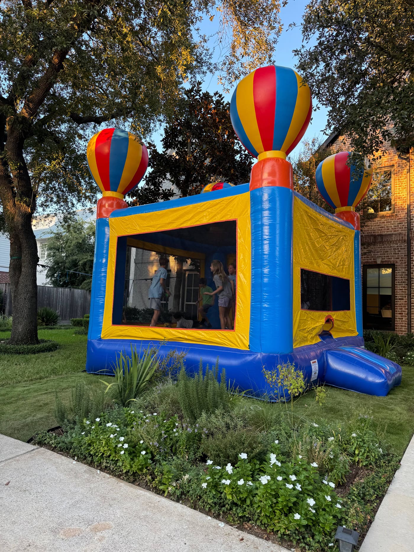 Kids jumping inside the hot air balloon bounce house